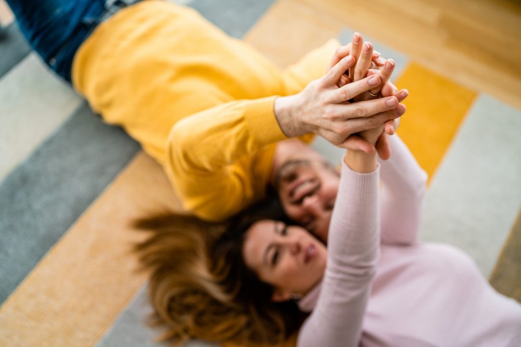 Happy woman and man in love holding hands. Trust, love, couple, unity concept